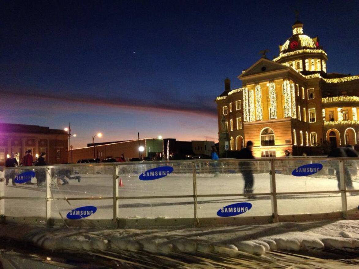 A scene from the 2013 Wonderland of Lights where ice skaters glide in front of the historic courthouse on the square in Marshall.